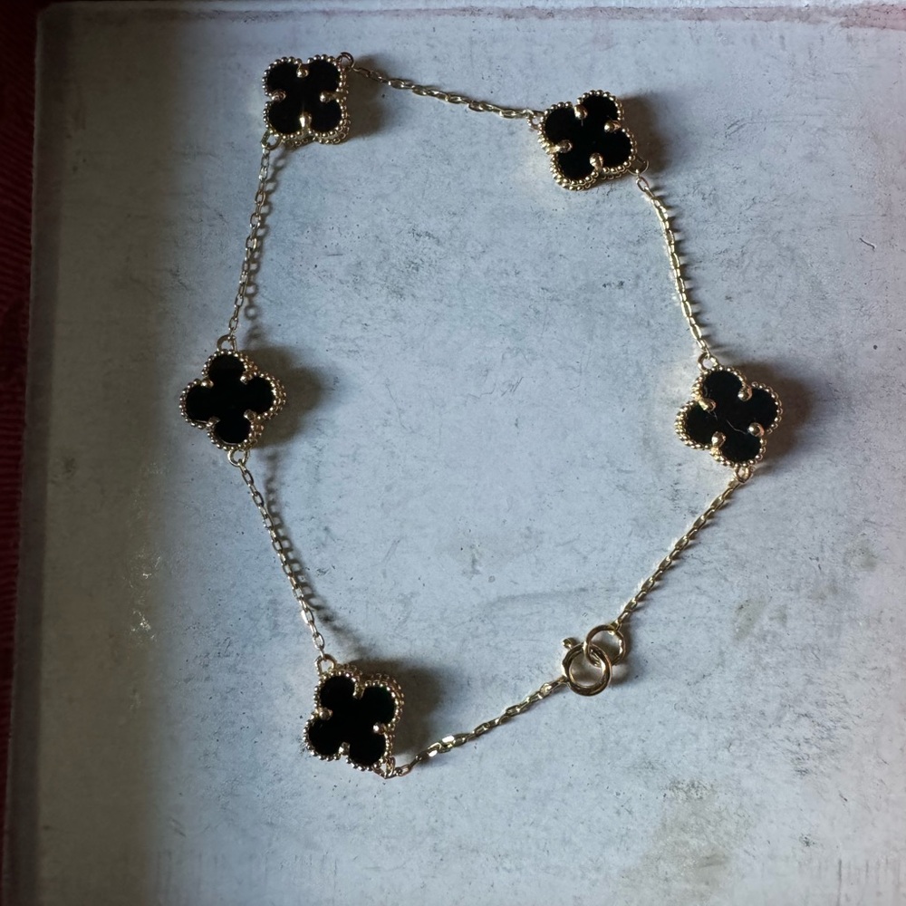 Clover bracelet real gold.It is real18k gold with black onyx. Can’t return item.